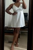 This little slip is absolutely adorable and exactly what I was looking for for my wedding getting ready outfit! Thankfully other brides had reviews with pictures, so I was able to decide on the Large, which fits great! It doesn't hug the body, and flows just right. I thought it would be a silk material, but it's actually a super soft cottonish fabric, which I like. Can't say I truly think it's worth $50 considering it is a teeeeeny bit see through, but I can't complain, I do love it. The lace at the top is very bridal. The adjustable straps help to get my boobs sitting in the right place. I do have a larger chest as a 38D, and really love the look of it. It's not one of those styles where if your boobs don't fit in the "slots" it looks weird, it is actually really flattering on small and large chests I think. I'm 5'2 so the length is great for me as well, but I could see it being short on a taller woman. Overall 10/10 for me! I'll pair it with a white robe and some white slippers for the big day! - Zafyre S.
