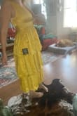 This dress is very cute, it is textured and has a nice feel. The dress fits perfectly, especially in the bust, but the very top of the zipper in the back does get a little tight, but if I sized up the dress would for sure be too big. - Cassidy M.