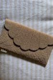 I love this clutch. The beading is gorgeous and the size is perfect. I removed the straps and actually prefer it that way. I was able to fit my iPhone 15 Pro along with cards, cash, and chapstick. My photo looks dark but it is light like the listed image. - Riana T.