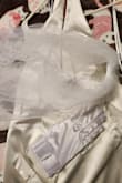 Dress is pretty and material is good. The color is not as white as expected though. Not white like it looks on site. I have included a photo of the dress underneath my white veil/gloves for reference. - Ashley M.