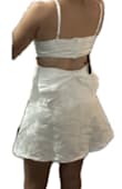 A little too preppy for my style. Skirt stays popped out. Very white. Bra clasp allows for a little bit of adjustment. I'm usually medium/large. This felt a tiny bit large on me but I'd have it tailored had I kept it. - Sarah D.
