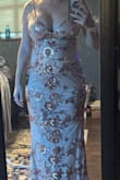 Initially, I ordered a small and was unable to zip it closed, so I returned for a medium. I typically wear a size 6. Dress is more gold and less rose than in the original photo. It's a nice dress for the price. Shows too much cleavage for my comfort. - Miranda B.