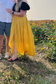 The pleating make a nice camouflage for any belly. The yellow is like a sunflower color! I wore it to a sunflower field and it was so cute! Perfect length, perfect slit. Love love. I bought the other color too! - Kristen B.