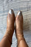 I am a true size 7, although my feet are a bit wide, but I still fit into 90% of size 7 shoes. The size 7 in these boots didn't even come close to fitting! I ended up ordering an 8.5 taking a shot in the dark, and they fit perfectly! I have NEVER owned a pair of 8.5 shoes but here we are. 
The color isn't even remotely close to the photos and certainly should not be called "light nude". They are definitely brown!! It's fine because I still like them, but all around you're not gonna get what you're ordering if you order your true size and want light nude color. - Helina B.