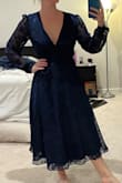 This dress is just as it's pictured! Nice and flowy with a plunging neckline. You're able to tie the strings as tight as you'd like to make a snatched waist. Watch out though, you cannot tie it loose because the tie is the only thing keeping it closed! - Erin P.