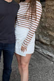This shirt is super comfy and fits well! Absolutely love it. Length and amount of stretch were great, arm length was a little long but I don't mind that, and pretty a little bit looser clothing anyways. Material is pretty soft/comfy. Shirt is cropped, skirt was high waisted. - Hannah B.
