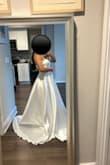 I bought this with high hopes and it definitely delivered. The dress is absolutely beautiful. Everyone thinks I look like a princess. The quality is absolutely shocking for the price because it is such good quality. I barely have to make alterations but because I'm 5'2 and I just have to trim off a bit. Wasn't a fan of the bows so I took those off. Overall, it's amazing I won't shut up about how great it is.
The dress is timeless because it is very elegant and classy. It it has a shine to it. - Julie L.