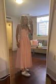 Such a cute dress!! I'm petite so I was nervous for how it would fit but it was so good!! I'm 5 feet tall which made it about ankle length. It wasn't snug but fit comfortable (if a little loose). I wore it to a tailgate and a noon game it was actually quite breathable. GET IT!!! - Reagan N.