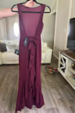 It's a beautiful dress, fits snugly to the body and accentuates the silhouette. The fabric quality is perfect, and very strong with impeccable finishing. I didn't need to make any alterations. The color is lovely, somewhere between plum and burgundy. - Marianny M.