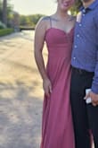 The dress was really pretty in person. The slit in the side did go all the way to to the waist lining, but that wasn't a big deal. The worst part of the dress was how warm it got.  I wore this dress for a outdoor wedding at 90°+ outside - it was killer. It definitely fit like an XL - Which was perfect for my waist but too big for my non xl sized chest. A little fashion tape did the trick though, no one (hopefully) got flashed. - Aria W.