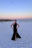 This dress is perfect and I can't wait to wear it again! The material is thick but wasn't too thick for a beach wedding. The neckpiece is EVERYTHING. I was told that I looked like a vampire, that I looked like Mrs. Smith, and that I looked like a high fashion model. Not just gassing myself up! This dress is everything. The bust was slightly loose, but I have itty bitty titties so that wasn't a shock.

Size S was perfect; XS would've been too tight and form fitting. - Lauren D.