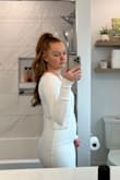 Wore this dress when I eloped and it was perfect! I was looking for a dress that would look bridal without being too fancy and this dress nailed it. It's super simple yet so elegant, it was absolute perfection. The fabric was also gorgeous! It is a thicker fabric with a beautiful, but subtle, texture and hugged my body in all the right places. Depending on the brand I'm usually a size XS or small but I've purchased other dresses from Lulus and have always fit into a small perfectly and this dress was the same. I would say the dress was a bit snug, but I'm also 3 months postpartum so I'm carrying a bit more weight than usual and the small still fit me. I don't have a photo without a cardigan on (we had a fall wedding) but in the photo I'm uploading you can see how the dress hugs my waist and you can also see the subtle texture of the fabric. - Michelle W.
