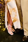 The shoe is beautiful, but the design in the back kind of pinched the back of my right heel. The left side was fine. Maybe it was the way I walk, but it wasn't the most comfortable. But the shoe was beautiful and complimented the dress very well. I got the silk white. - Chera M.