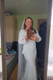 This dress is simply beautiful and classic. It's made of a beautiful material which is really comfy. I will need to have the sleeves, arms and length altered, but other than that, it's perfect. Really happy with my purchase. I have added a pearl belt to it to cover the little line. - Karolina
