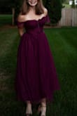The dress color is a bit more purple than shown.  It is a plumish burgundy. I received all the compliments on this dress. Fit to perfection and was so comfortable for the whole night. Also love that I can wear this to other events I have coming up too. - Nichole S.