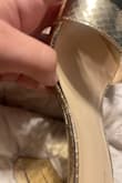 Here is a photo of a little damage to the shoe when I received it. It needs more glue. Also, no one's toes are that narrow to fit inside the strap & ouch. - Sierra K.