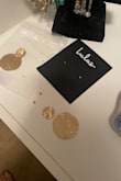 The earrings were nicely packaged but arrived broken. - Patti D.