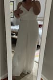 This jumpsuit fits SO nice (I'm a size 12, 205lb, 5'6''). It's stretchy material and the string in the back really allows for a more custom size. It's a bit see-through in the chest so pasties are a MUST and the back is a bit revealing (shows my back rolls, iykyk) so I most likely won't be wearing this for our fancier rehearsal day BUT it's a perfect getting ready outfit OR day-after-wedding run some errands/brunch outfit. Could easily throw on a shawl/jacket and avoid the revealing backside OR if you're not afraid to flaunt it, rock it out, babe! - Abbey-Rose B.