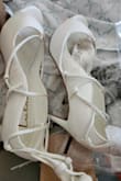 These shoes were definitely used and returned. The strap where it's supposed to lace up is broken. Very disappointed - Amanda B.
