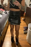 I'm definitely in between sizes. I'm 5'0, a muscular 124 lbs, hips 38". I think my waist is like 28", and I'm usually an xs to an s depending on the material. I ordered a small, pictured, and it was just weird on me. Too long for my taste, very baggy across the front yet still fitted on my butt. I exchanged it for an xs, also pictured, and I can barely zip it. It has to sit very high on me to get into it. The zippers were very stubborn on both skirts. I love how it looks and the little slit and it seems like nice quality, but I think it's built for nonathletic girls. I overall love it, just wish the sizing wasn't weird - Katherine W.