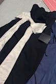 This dress is wonderful; the fabric is knit and the bow is satin; the quality is excellent, and it fits very well on the body. I loved it - Osana A.