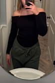 This is a great top to wear out. It's long enough that you can comfortably tuck into pants or a skirt. The sleeves are also long and could probably cover my whole hands if I wanted them to. There is also a lot of extra material around my waist area, so I feel like I'll be pulling it down a lot to smooth it out. I don't think I would size down though because then it might be too tight around my arms or shoulders. I also don't like that the section at the top that's folded over isn't sewn like that & so you have to fold it yourself. It's not a big problem, I just hope it doesn't unfold itself. I still think the material itself is good quality though and looks good! - Kamila P.
