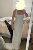 I ordered this as a "back-up" option to the dress I was originally wanting; I wanted something satin, timeless, and no sparkle- but this dress caught my eye and I had to see how it would look. I fell in love! I am normally a small, but decided to order a medium just in case. The medium fit me perfectly, like a small normally would, but the straps are a little loose/big. I selected that the fit is a little small because I feel like a size small would have worked for me, but probably would have been a little too tight, and I was going for a more loose/flowy fit. The dress is VERY long, even in heels I was tripping over the front. The train is just a little longer in-person that shown on the model, which I love. Heavy material as well! Still a little see-through even with the liner. I was really worried that all the beading on the dress would look cheap in-person, but it is really well done and looks like some $2,000-3,000 dresses I've seen from other bridal designers. - Mary M.