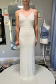 I got this as a back up dress for my wedding reception. It was a last minute Hail Mary as I had major fit issues with my dress. This fit perfectly, outside of being a little long. It was easily hemmed and put a bustle in it. Very flattering, love the beading pattern. - Katelan A.