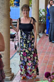 The bride requested "colorful garden black-tie attire". This dress was perfect for my 63 year old body. I usually wear a small or medium size top and size 8 bottom. This is a size large dress. I am 5'9 and wore 2" heels. It touched the ground a slight bit. I had to add material across the top because I'm a 36D and I didn't want my cleavage crack showing. You can see this same thing on the model. If you're smaller than 36D, it would be perfect. The top was stretchy, like fishnet pantyhose. I wish it had more structure/form for hold on the sides under the arms. The top is stretchy, and the skirt is not. It's a more substantial and firm fabric. The skirt had beautiful 3 dimensional flowers. I absolutely loved wearing this dress! The zipper was broken, but customer serve took care of it immediately. They were easy to contact and very nice. - Linda E.