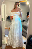 I purchased this dress as a potential option for my engagement photos. While it has a romantic design, the off-the-shoulder fit didn't work for me. It felt a bit tight, and the little belt didn't have the structure I expected, tending to droop and take away from the overall look. Ultimately, it didn't quite fit the vibe I was going for, so I decided to return it. The return process was straightforward; however, it's worth noting that Lulus charges a $2 restocking fee per item, and they also deduct $7 for return shipping. So if you're considering a return keep these fees in mind. - Stephanie H.