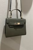 Matches H Kelly bag style to a T. Fits my work and personal phone along with my wallet just fine. An absolute steal. - Carley J.