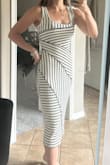 Absolutely love the way this dress fits. Hugs my curves very nicely. Great midi length. Looks just like the pictures. Great for date night for a casual shopping day alike. Thick enough material you can't see through, but won't overheat. Great deal! - Carley J.
