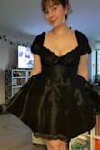 The fabric is different than I suspected and a bit stretchy. I might have sized down had a known, but I think the dress is great. I'm planning to wear it to some holiday parties. Picture is with no bra. - Camille S.
