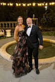 Although I am between sizes according to the size chart and I was. I had to order 2 sizes. It was absolutely beautiful and stunning. I had a black-tie wedding. - Elizabeth O.