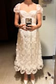 The dress has a lot of fluffy lacy detail that doesn't show up in the photos but looks super weird in person. The fit is awkward and looks very boxy even though I'm relatively curvy. I felt like a 5 year old dressed up for church. I think if you have a very petit figure it could work, but for most body types it just doesn't. - Dahlia K.