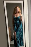 I fell in love with the colors and style of this dress. I ordered a size small which fits perfectly.  I will have to hem it a bit but more because I don't plan on wearing heels or maybe not any shoes at all since the wedding will be on the beach. The material is soft and feels expensive. There isn't any give so the top part is a little tight but still ok. It flows over my hips but fits at the waist which is flattering. Perfect for my beach renewal. - Jennifer R.
