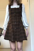 I got it for Thanksgiving, and it's really cute, but big. I got a size small, but it was much bigger, and I'm a pretty standard size small. I reordered it in an extra small, a little worried. I'm 5'8 and have had issues with Lulus dresses being too short and I was worried a size down would be too short, but it's the perfect length. It's big through the armpits and the straps are still a little long on me, granted I have small boobs and pretty narrow shoulders, so most dresses fit me a little weird through there. I would go a size down though unless you're on the bustier side. The fabric is really thick, which is nice. And it's great bc you can wear it without a shirt underneath when it's warmer or layer incredibly easily. - Claire W.
