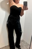 I was very disappointed in the bottom have of this jumpsuit. The top half fit great and is lovely black velour, not velvet. I have a large chest and the top actually fit. The bottom half is this mesh overlay. Not what was expecting at all. It is very snug on my thighs and butt. I don't like the way it feels. I wear a size 6 and thought the Medium would fit great after reading the reviews. Unfortunately, only the top half fit. The waist is a little big so sizing up isn't an option. - Amy M.