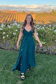 I loved this dress so much. Everything I wanted. I loved the ruffle going down the dress. The split wasn't too high. The back detail was super cute and made it very adjustable. The material was soft and felt good on my skin. I'm 5'6 and the dress was still too long with heels so I did have to hem it. Otherwise, it was perfect for [a] formal wedding guest dress - Melanie A.