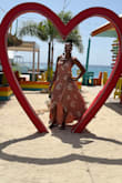 This beautiful dress is so flattering. The material feels great. It has a train and looks so classy. - Andrea C.