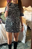 This is so cute! I wore to the eras tour and it was so so perfect for a midnights vibe. The dress is very short, so shorts under are a must (I'm 5'9 so I am tall), but I wouldn't size up unless you want it to be baggier overall. The sequins are super soft, and don't shed. There are little shoulder pads but nothing that should stop you from buying. - Kelly M.