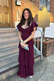 It's a gorgeous gown, in a deep purple with red under-hues.  So flattering.  It's very long, which works for me, but if you are on the shorter side, it'll need the highest of heels. - Nikki K.