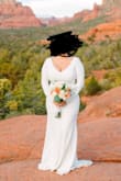 I bought this dress for my elopement in Sedona. The material is good, maybe a little thin, but not see through. I feel like it fit me pretty well. I have a bigger bust and I am definitely bigger than the model. (I made no alterations to this dress). I wore 2 inch heels with it. The only thing I did note was that the buttons down the back are a little flimsy (one of them came off of my dress). For me it was not a big deal. All in all, great value for the dress. - Cynthia M.