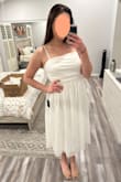 This dress is really cute! But I just feel like it has a lot of fabric and kind of puffs out, making me look bigger than I am. I'm in-between sizes and definitely could have gone with a large in this one, but even still I don't think the excess fabric issue would have been solved. - Margaux E.