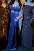 I wore this dress to a masquerade event. It is VERY LONG. I'm 5'9" and with 3" heels, it still dragged a bit. Beautiful color and great fit, not tight anywhere. I'm actually a 38I. I didnt wear a bra, and things stayed pretty well put. Im typically a size L or XL in tops and size 14/16 in jeans and dresses. - Adrienne W.