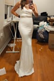 This was a solid option for my wedding. The fabric was thick and good quality and the dress hugged all the right places. I added a belt. I could have possibly went to a medium but hard to say without trying it on. This was a little snug but definitely wearable. - Erica E.