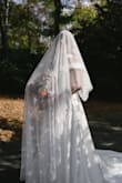 This is the most beautiful, perfect, wonderful, amazing veil ever. The flowers are 3D and don't take away from the dress, but are the most perfect touch. I got so many compliments and I wore the veil through cocktail hour and dinner because I didn't want to take it off! The quality is EXCELLENT!! - Bailey R.