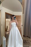 I am getting married in August and wanted to save money on a dress. I looked at countless sites but ended up ordering this one. The quality is thick and satin and I was very surprised that is was not more expensive. It has a sheer/shine to it. I planned on removing the bows to be more simple. I gave a 4 star because it was a bit too shiny for my liking. The bust area fit perfectly and was very flattering. Definitely a good option for a bride on a budget! - Kennedi M.
