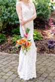 The pros outweighed the cons and I ended up picking this dress for my wedding after trying on many Lulus dresses. The pros are that it is extremely comfortable, stretchy, cute, and it was flattering on my body. 
The cons are that it was extremely expensive to hem. If you are short and pick this dress, be prepared to spend more than the cost of the dress on getting it hemmed. I believe my total cost was around $200. The bottom of the dress is detailed lace and there are pleats, which means it is not a quick and easy job. - Elizabeth M.