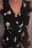 I got this shirt expecting there to be a lot of cleavage based on the model pic and the other reviews. I'm a 34D chest but with the clip secured and the wrap tied, there really wasn't that much cleavage (see picture). However, it is a very pretty shirt and fits great. I found that if I don't have the top clip secured, there is a lot more cleavage. That makes this shirt work well for day to night or work to date. Great buy! - Stella O.